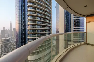 a balcony in a skyscraper with views of the city at HSHOME - Luxury 3 Bedroom Apartment with Burj Khalifa & Stunning Skyline View in Dubai