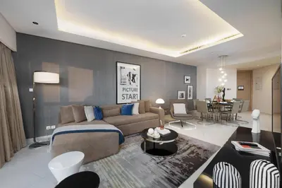 a living room with a couch and a table at HSHOME - Luxury 3 Bedroom Apartment with Burj Khalifa & Stunning Skyline View in Dubai