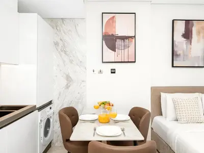 a small dining room with a table and chairs at Large modern STUDIO in STERLING DOWNTOWN I DUBAI MALL I Sleeps 4 I Amazing Balcony in Dubai