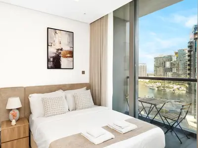 a bedroom with a bed and a large window at Large modern STUDIO in STERLING DOWNTOWN I DUBAI MALL I Sleeps 4 I Amazing Balcony in Dubai
