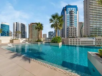 a swimming pool on the roof of a building with a city skyline at Large modern STUDIO in STERLING DOWNTOWN I DUBAI MALL I Sleeps 4 I Amazing Balcony in Dubai
