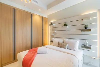 a bedroom with a white bed and a wall with shelves at RH - Luxury 2BR at Paramount Midtown, Burj Khalifa View in Dubai