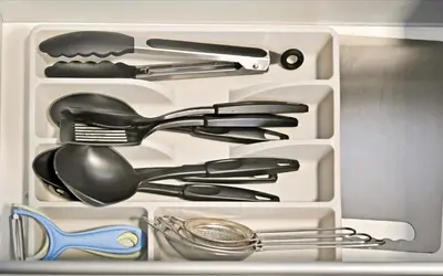 a drawer filled with utensils in a refrigerator at Modern 1BDR Apt With Balcony Pool Access And JVC in Dubai