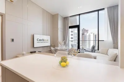 a kitchen and living room with a tv in a room at Luxury 1BR - Binghatti Phantom - Amazing Amenities in Dubai