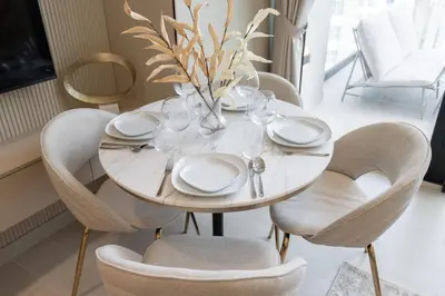 a white dining room table with chairs and a vase at Luxury 1BR - Binghatti Phantom - Amazing Amenities in Dubai