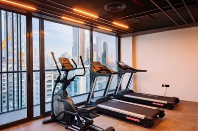 a gym with three exercise bikes and a window at Near World Trade Center Sleeps 5 Family Business Friendly in Dubai