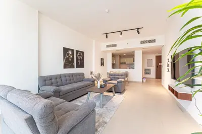 a living room with couches and a tv at HAVN - 2 bed in Hilliana Tower, Jumeirah Burj View in Dubai