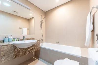 a bathroom with a sink and a tub and a toilet at HAVN - 2 bed in Hilliana Tower, Jumeirah Burj View in Dubai
