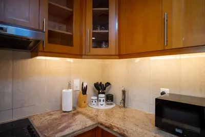 a kitchen counter with utensils and appliances on it at Luxury 2BR Haven with Panoramic Scenery - The Greens in Dubai