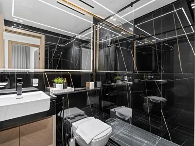 a black bathroom with a toilet and a sink at Charming 2BDR Stay in Binghatti Corner- JVC in Dubai