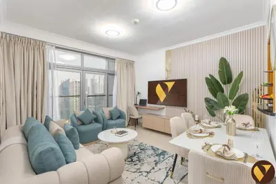 a living room with a couch and a table at Vogue JLT Global Lake View Tower near Marina and JBR, Two Bedroom Apartment with Balcony and City view, Access to all Amenities in Dubai