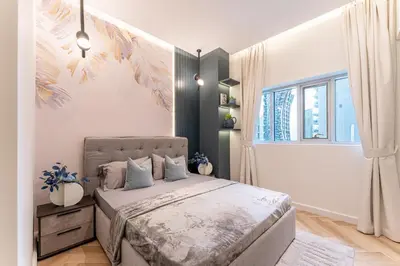 a bedroom with a bed and a window at HAVN- 3 bedroom in DAMAC Majestine, Business Bay in Dubai