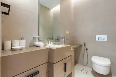 a bathroom with a sink and a toilet and a mirror at Sea View, Direct Beach Access - The Address Residences, JBR by Deluxe Holiday Homes in Dubai