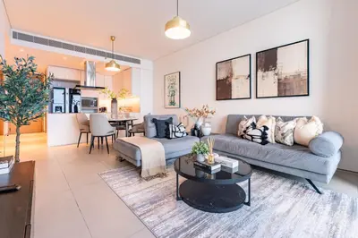 a living room with a couch and a table at Sea View, Direct Beach Access - The Address Residences, JBR by Deluxe Holiday Homes in Dubai
