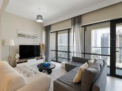 a living room with a couch and a tv at Opulent Haven 2BDR w Sofa Bed Sleeps 6 In Vida-02 in Dubai