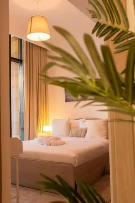 a bedroom with a bed and a potted plant at Large Beautiful One Bed Downtown Dubai in Dubai