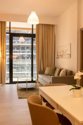 a living room with a couch and a table at Large Beautiful One Bed Downtown Dubai in Dubai