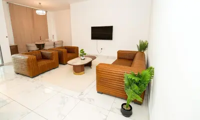a lobby with couches and a table and a tv at Skyline & Islands View 3BR Luxe Top Floor Noura Tower Business Bay in Dubai