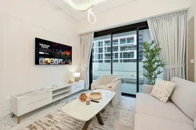 a white living room with a couch and a table at Bloomfields Grandeur 2BR in Azizi Riviera in Dubai