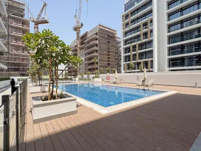 a swimming pool in a city with tall buildings at Bloomfields Grandeur 2BR in Azizi Riviera in Dubai