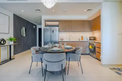 a kitchen with a dining room table and chairs at TRPS - Burj Crown, Downtown - Skyline and Pool View, Furnished, Downtown in Dubai