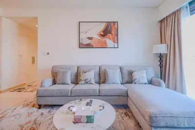 a living room with a couch and a table at TRPS - Burj Crown, Downtown - Skyline and Pool View, Furnished, Downtown in Dubai