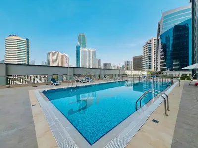 a large swimming pool on top of a building at HAVN- High floor 1 bedroom in Business Bay in Dubai