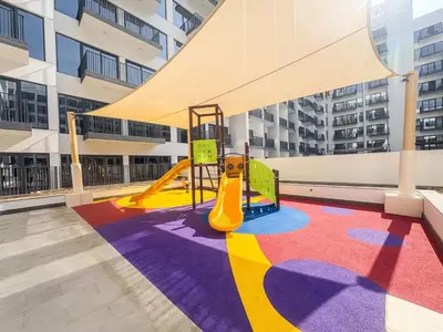a playground in a building with a slide at Frank Porter - Azizi Beach Oasis in Dubai