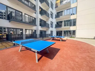 a ping pong table in front of a building at Frank Porter - Azizi Beach Oasis in Dubai