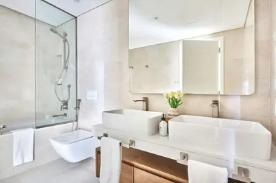 a white bathroom with a sink and a mirror at Frank Porter - Al Jazi in Dubai