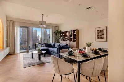 a living room with a dining table and a couch at 4BR - Stunning Burj View - Dubai Mall Access in Dubai