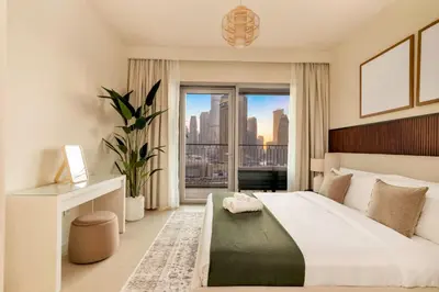 a bedroom with a large bed and a large window at 4BR - Stunning Burj View - Dubai Mall Access in Dubai