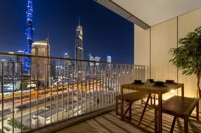 a balcony with a table and a view of a city at 4BR - Stunning Burj View - Dubai Mall Access in Dubai
