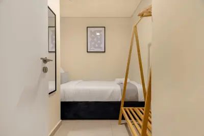 a bedroom with a bed and a mirror at 4BR - Stunning Burj View - Dubai Mall Access in Dubai