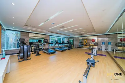 a gym with treadmills and elliptical machines at The Cosmopolitan Spacious Studio in Dubai