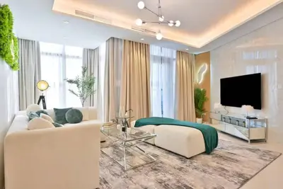 a living room with a couch and a tv at Paramount 10 Min to Dubai Mall, Luxury Amenities in Dubai