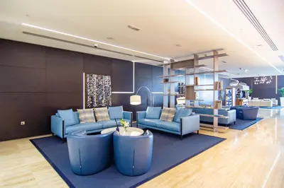 a living room with blue couches and a table at VayK - Stylish 2BD in Dubai Marina Near the Beach in Dubai