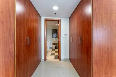 a hallway with wooden doors in a room at HAVN - 3 bedroom in Park Towers, DIFC in Dubai