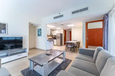 a living room with a couch and a table at HAVN - 3 bedroom in Park Towers, DIFC in Dubai