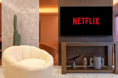 a living room with a chair and a tv at Burj Khalifa View, Luxury 2B, Top Amenities and Equipment in Dubai