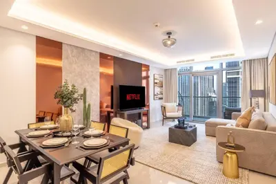 a living room with a table and chairs and a tv at Burj Khalifa View, Luxury 2B, Top Amenities and Equipment in Dubai