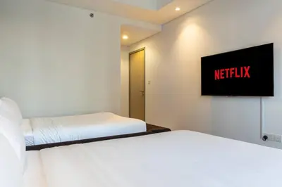 a bedroom with two beds and a tv on the wall at Burj Khalifa View, Luxury 2B, Top Amenities and Equipment in Dubai