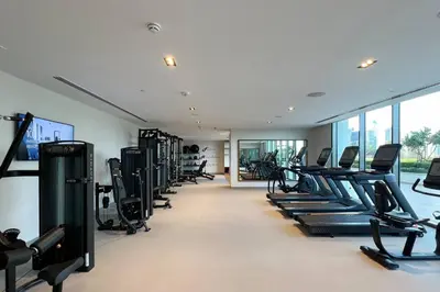 a gym with rows of treadmills and elliptical machines at Mahogany 25 - 2BR 10 Guests - Walk to Dubai Mall in Dubai