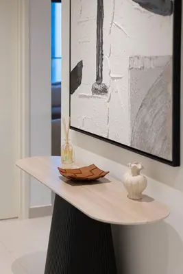 a table with a picture and a vase on it at Mahogany 25 - 2BR 10 Guests - Walk to Dubai Mall in Dubai