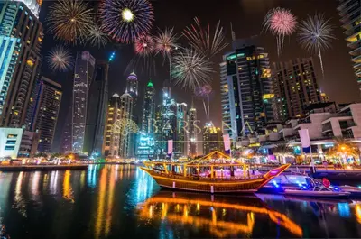 a boat in the water with fireworks in a city at Barsana - Azure Marina Apartment - 3Bed - Full Marina View in Dubai