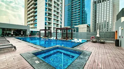 a large swimming pool on a building with tall buildings at Barsana - Azure Marina Apartment - 3Bed - Full Marina View in Dubai
