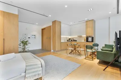 a bedroom with a bed and a living room at Serene Studio in Al Barari Near Dubai Hills Mall in Dubai
