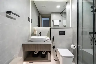 a bathroom with a sink and a toilet and a shower at GuestReady | New 1BR with Maid’s Room | Spacious in Dubai