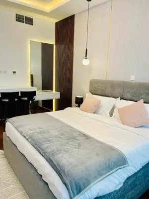 a bedroom with a large bed and a desk at Modern Studio With Scenic Views in Dubai