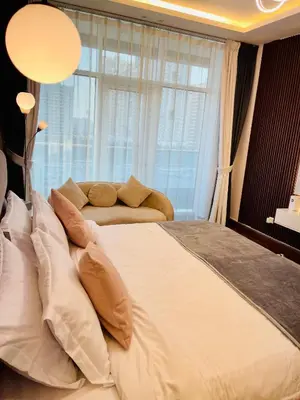 a large bed in a bedroom with a large window at Modern Studio With Scenic Views in Dubai